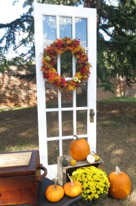 Beautifully decorated antique door at a fall wedding